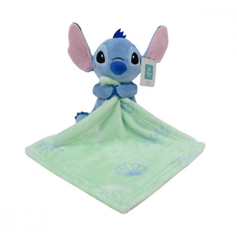 Η φωτογραφία δείχνει Λούτρινο Disney Home Stitch ύψους 25 cm με πανάκι παρηγοριάς (doudou) coral fleece με εμπριμέ σχέδιο στην αγκαλιά του, διαστάσεων 30X30 cm.